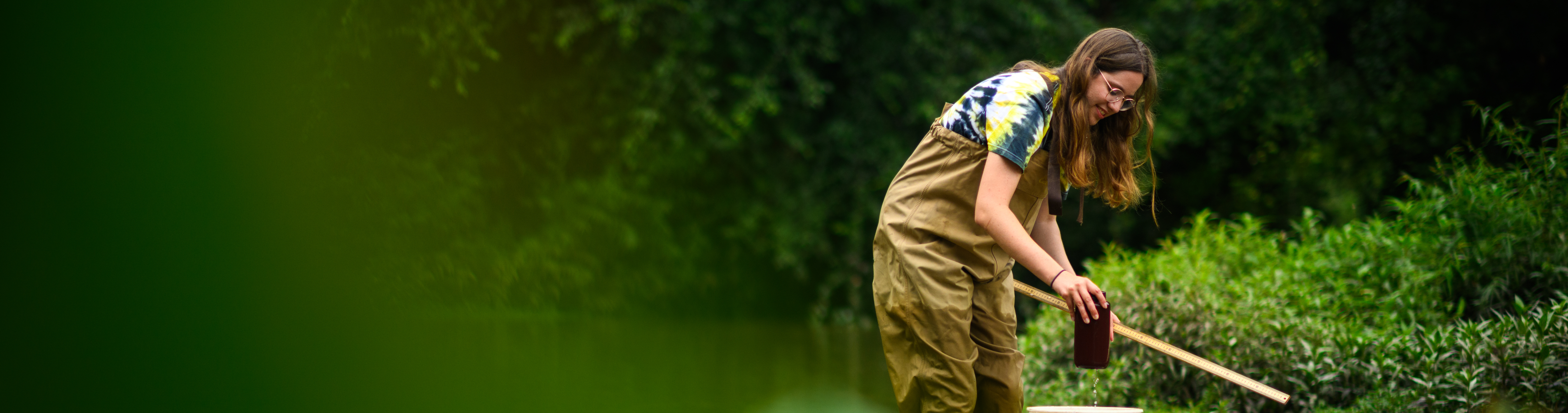 researcher collecting samples in the James River