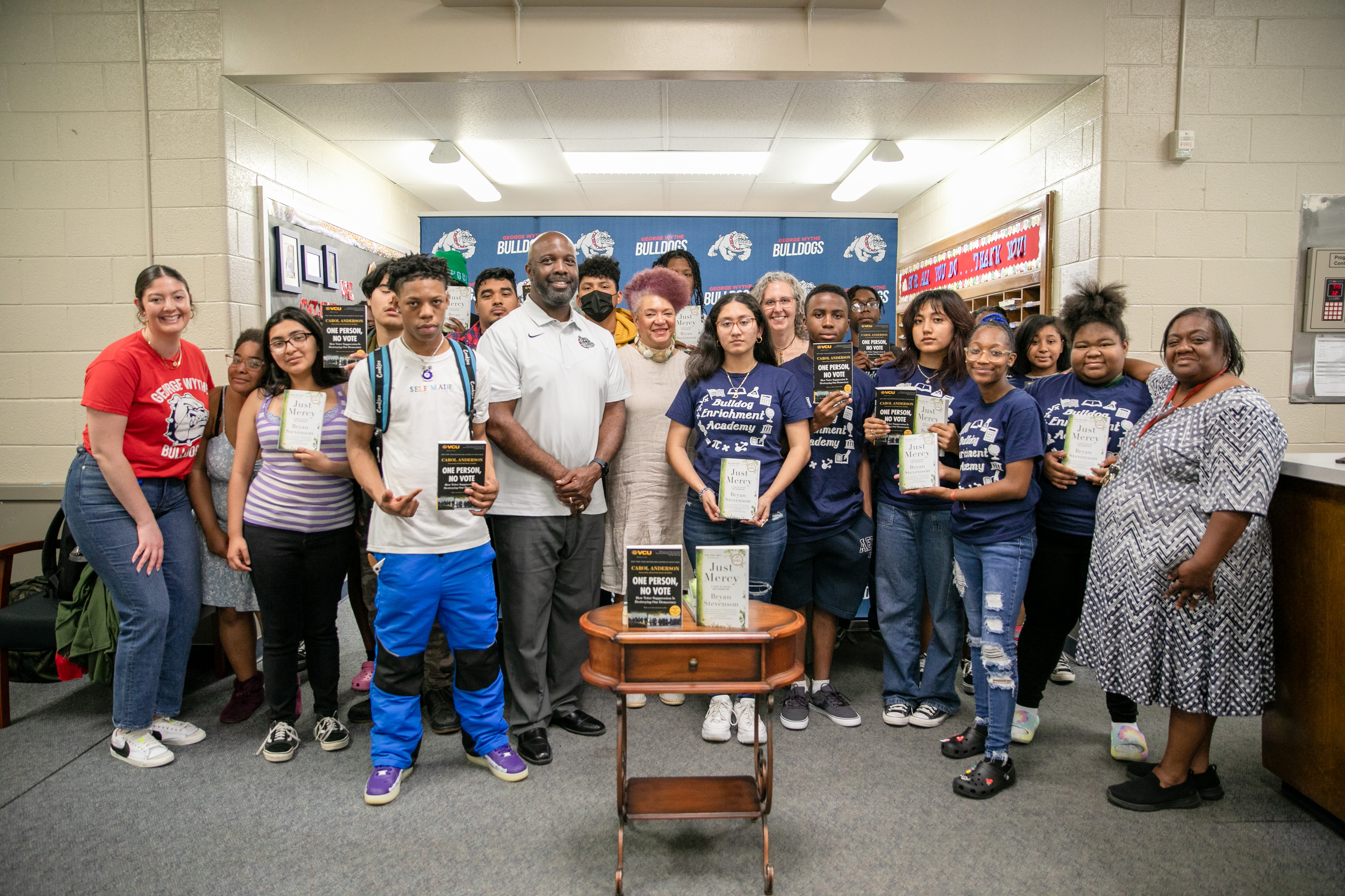 University College Interim Associate Dean, Stephanie Rizzi, and textbook Coordinator Vicki Pallo pose with students and faculty at George Wythe High School